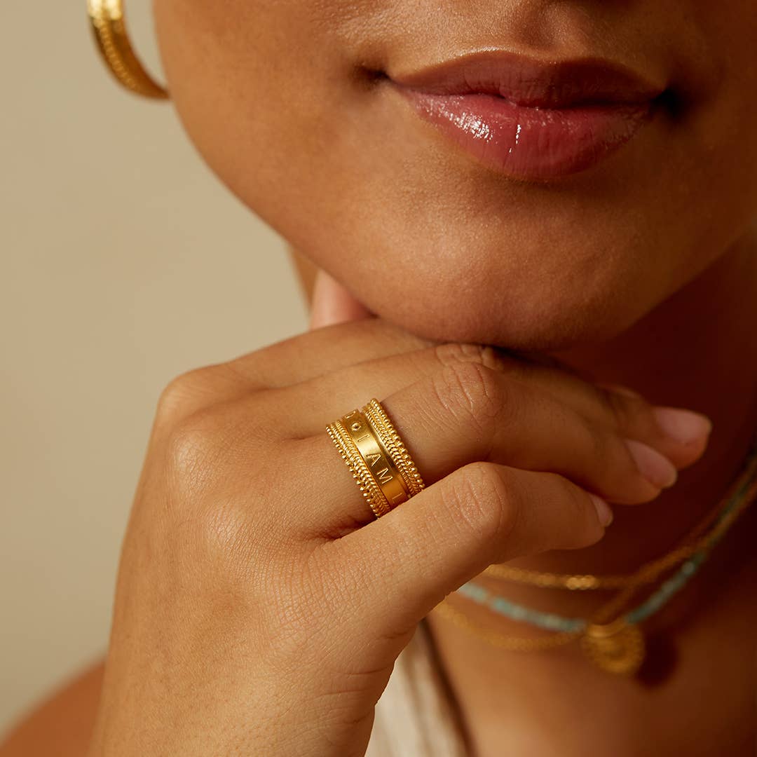 close up of a model wearing the love ring on their ring finger