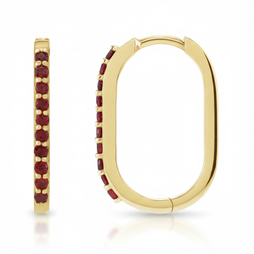 Gold hoop earrings with red gemstones on a white background