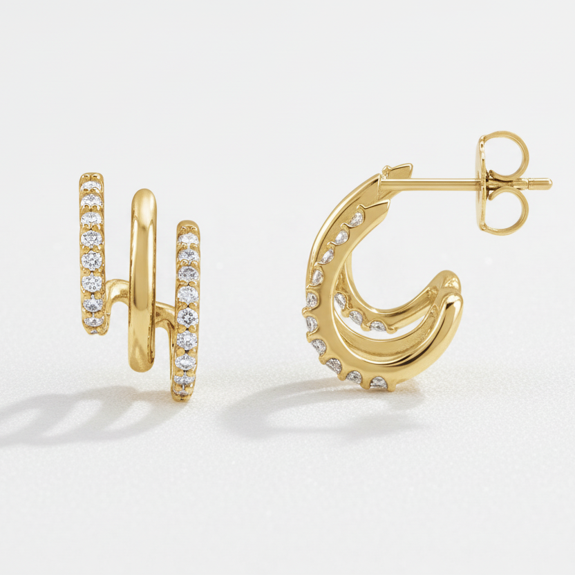Gold hoop earrings with diamond accents on a white background