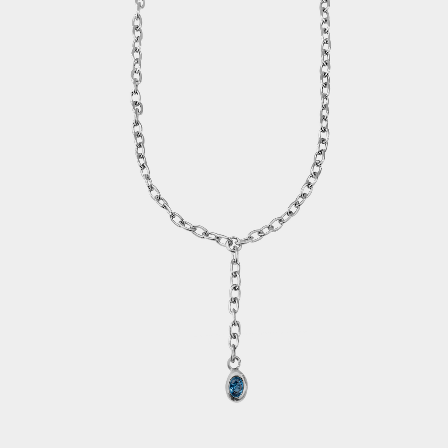 Silver chain necklace with a blue pendant on a white background