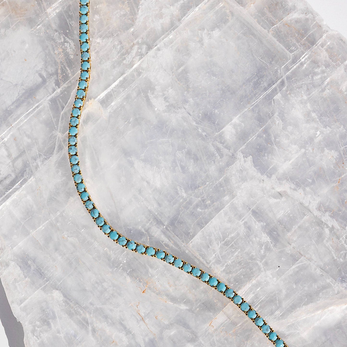 Turquoise bracelet on a marble surface