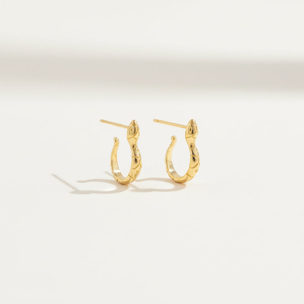 Gold hoop earrings on a white background