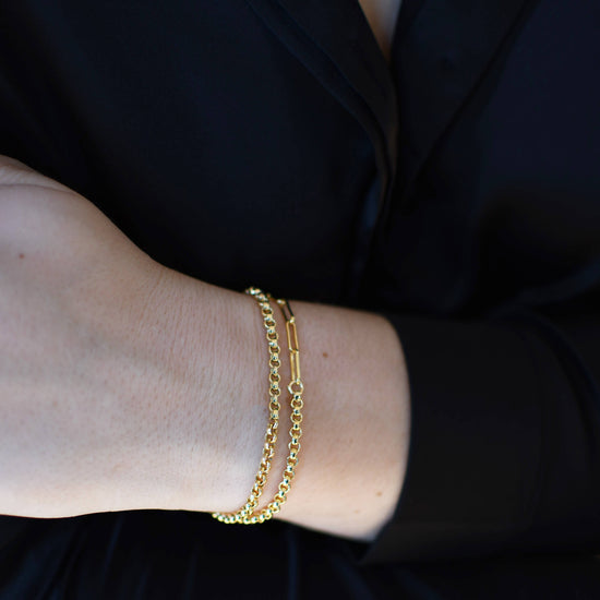 close up of a model wearing two dual chain bracelets