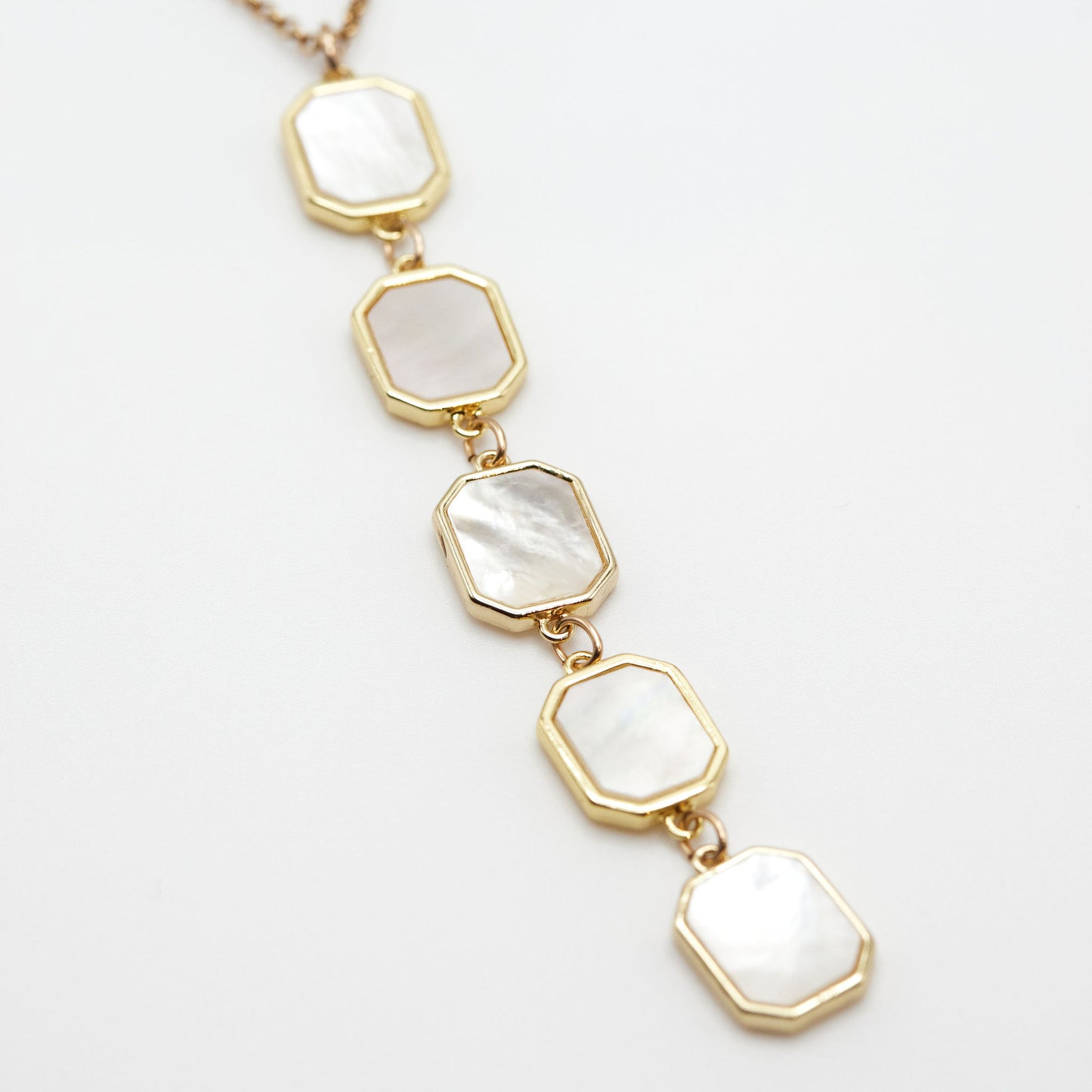 Mother of pearl drop necklace on white background