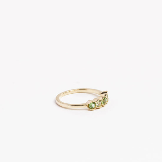 side view of the green garnet 5 gemstone ring on a white background