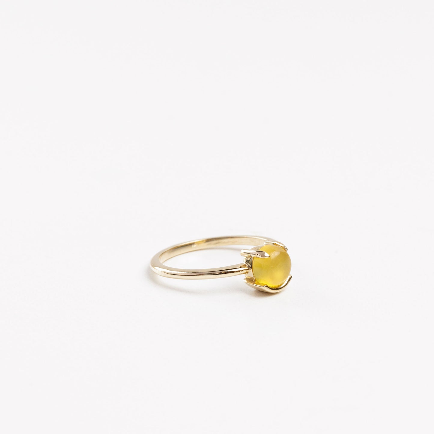 side view of the mango smiley ring on a white background
