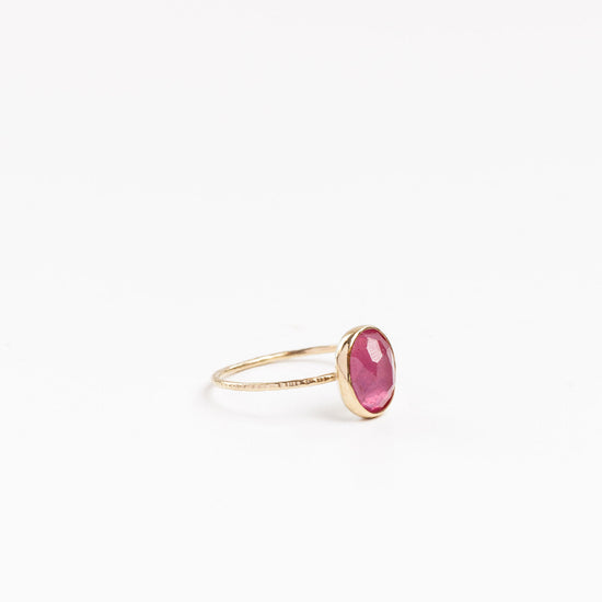 side view of the hot pink oval tourmaline ring on a white background