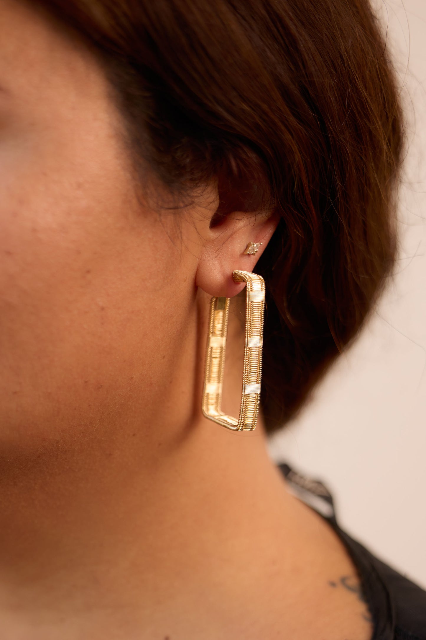 woven gold hoops on model