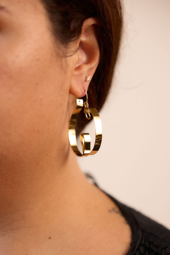 Curl hoop earrings on model