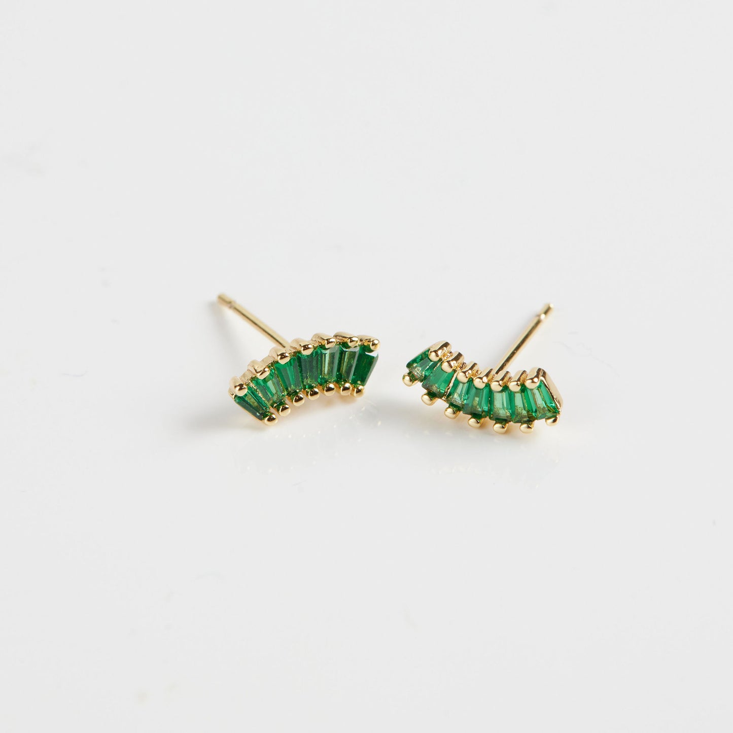 Baguette arc studs on white background