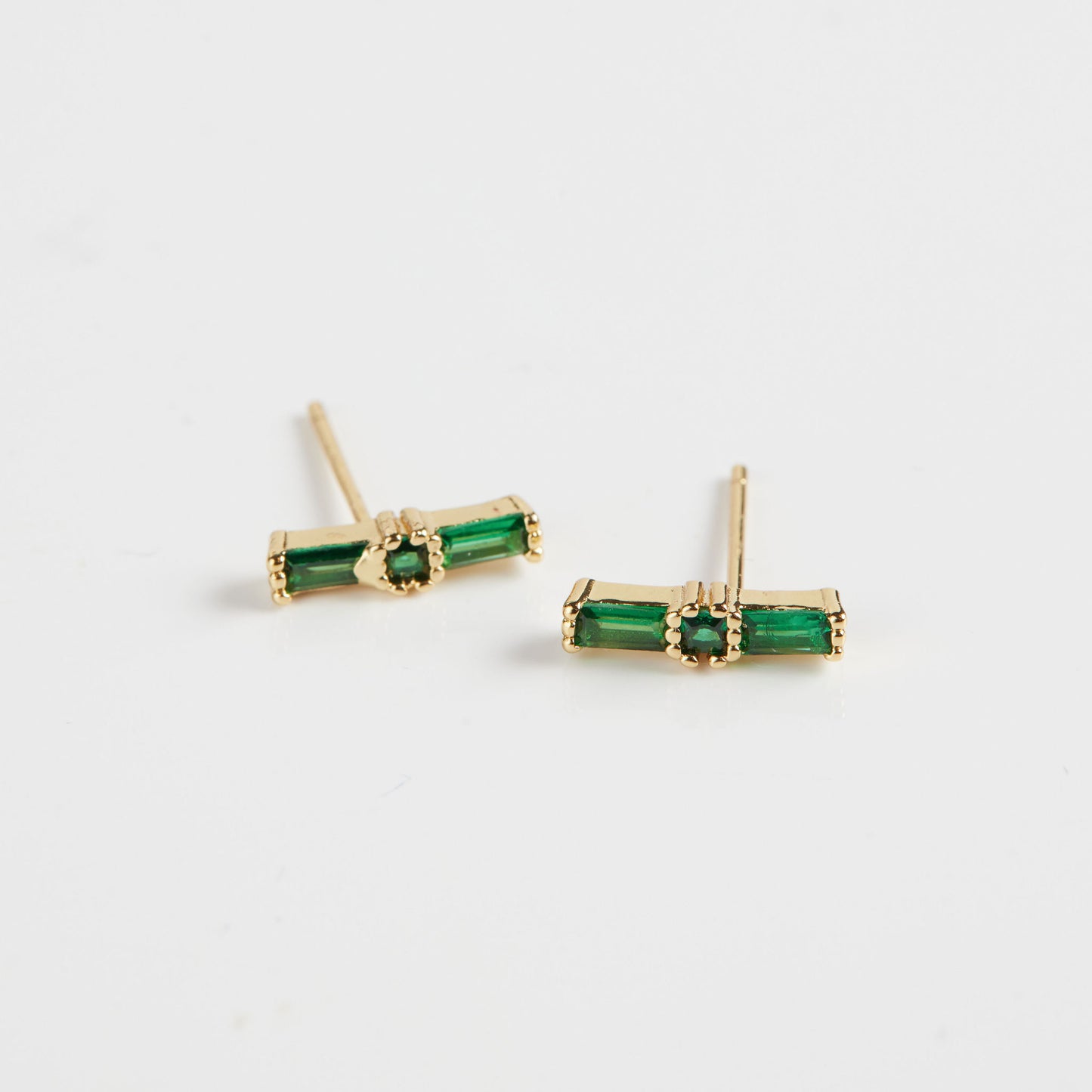Emerald baguette studs on white background
