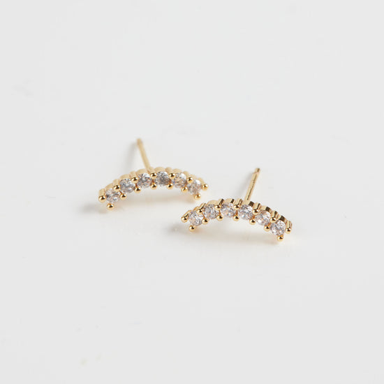 Crystal arc studs on white background