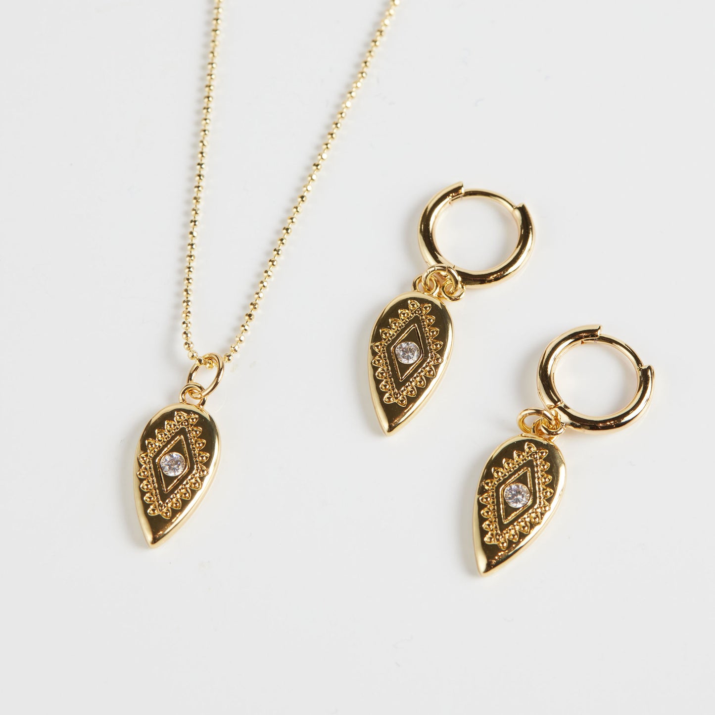 Paisley eye hoops and pendant on white background