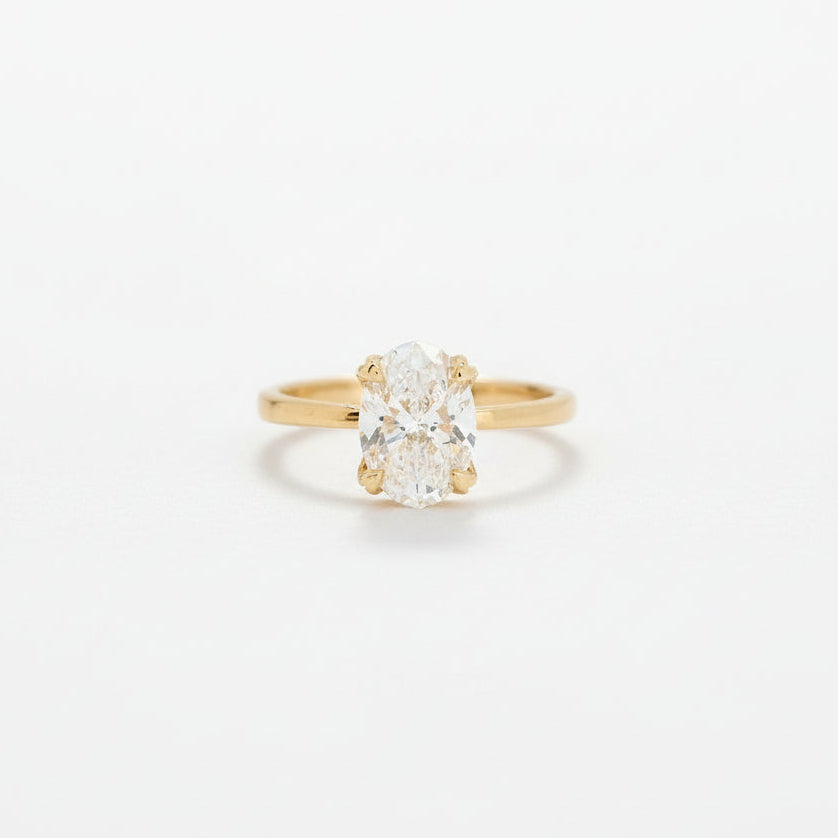 Gold ring with a diamond on a white background