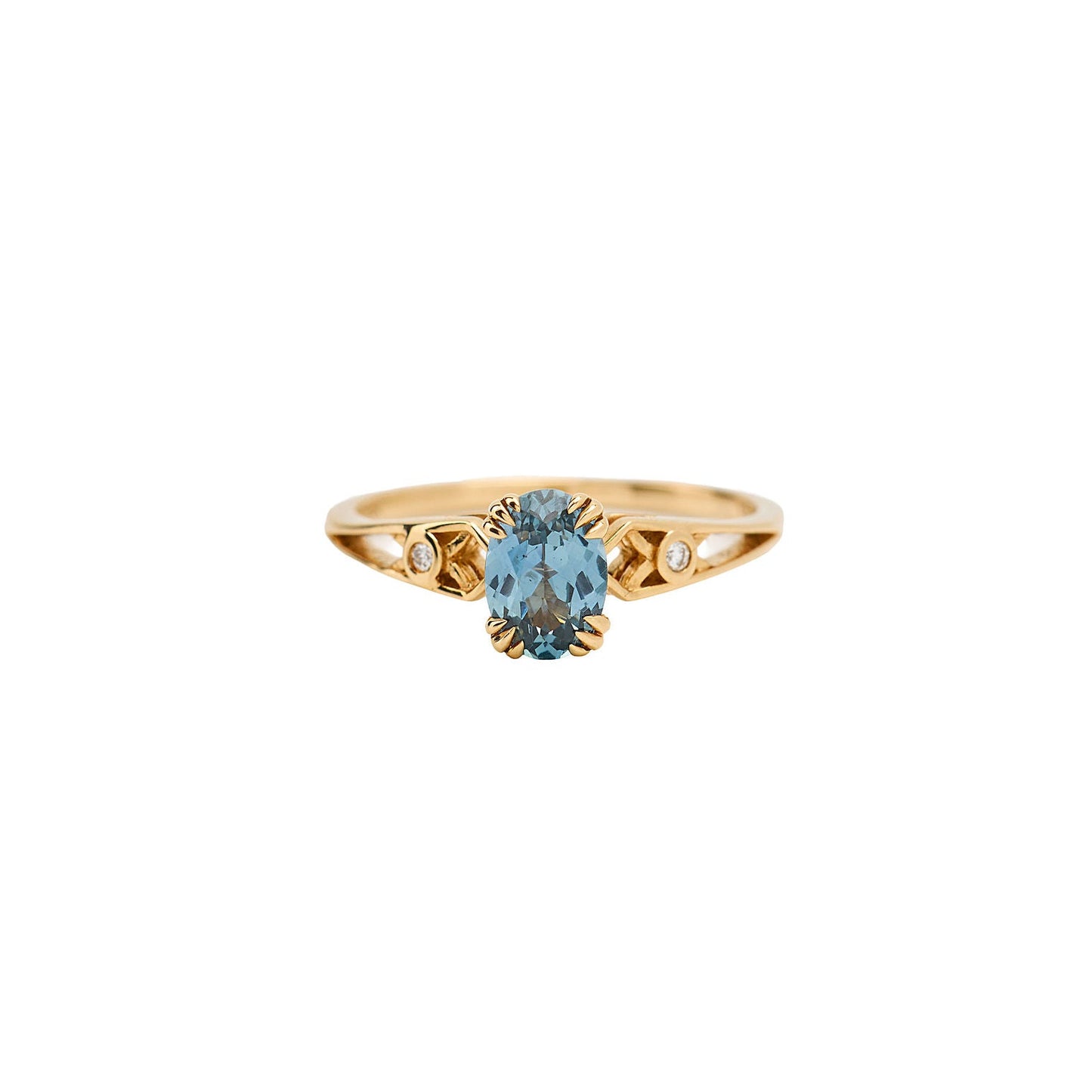 Gold ring with a blue gemstone on a white background