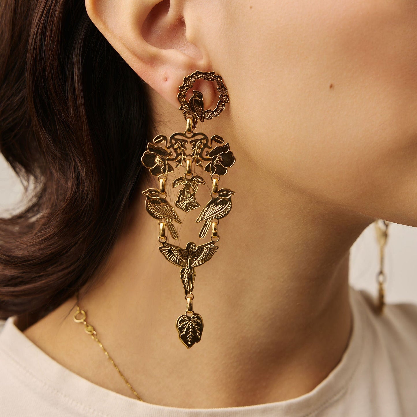 Close-up of a woman wearing an ornate gold earring.