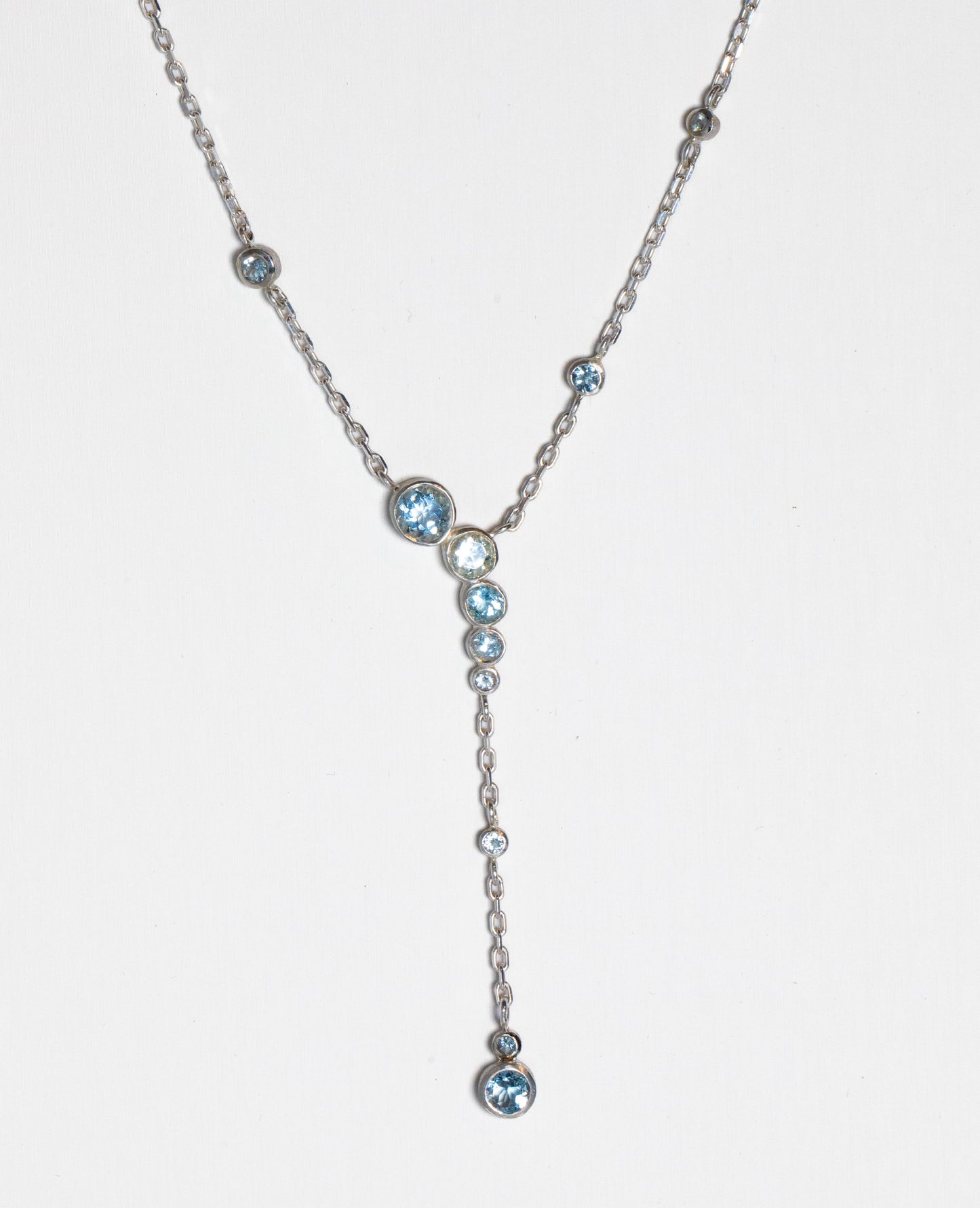 plunging aquamarine necklace on white background