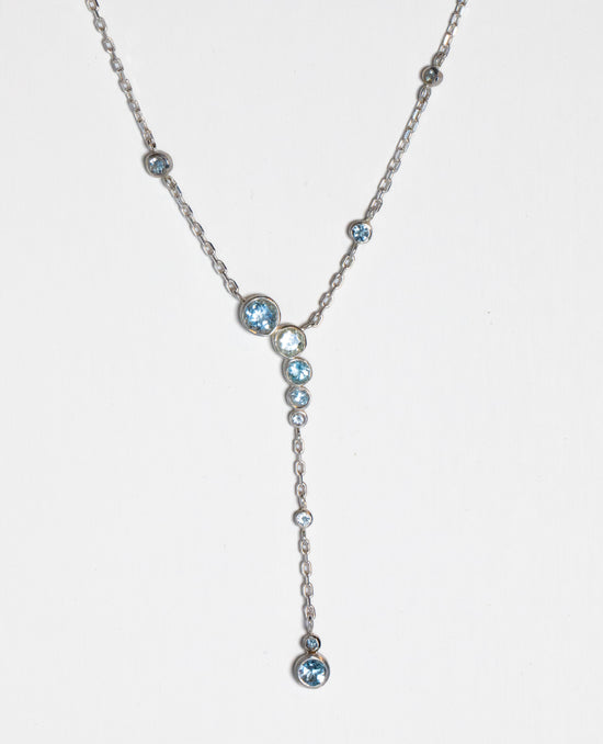plunging aquamarine necklace on white background