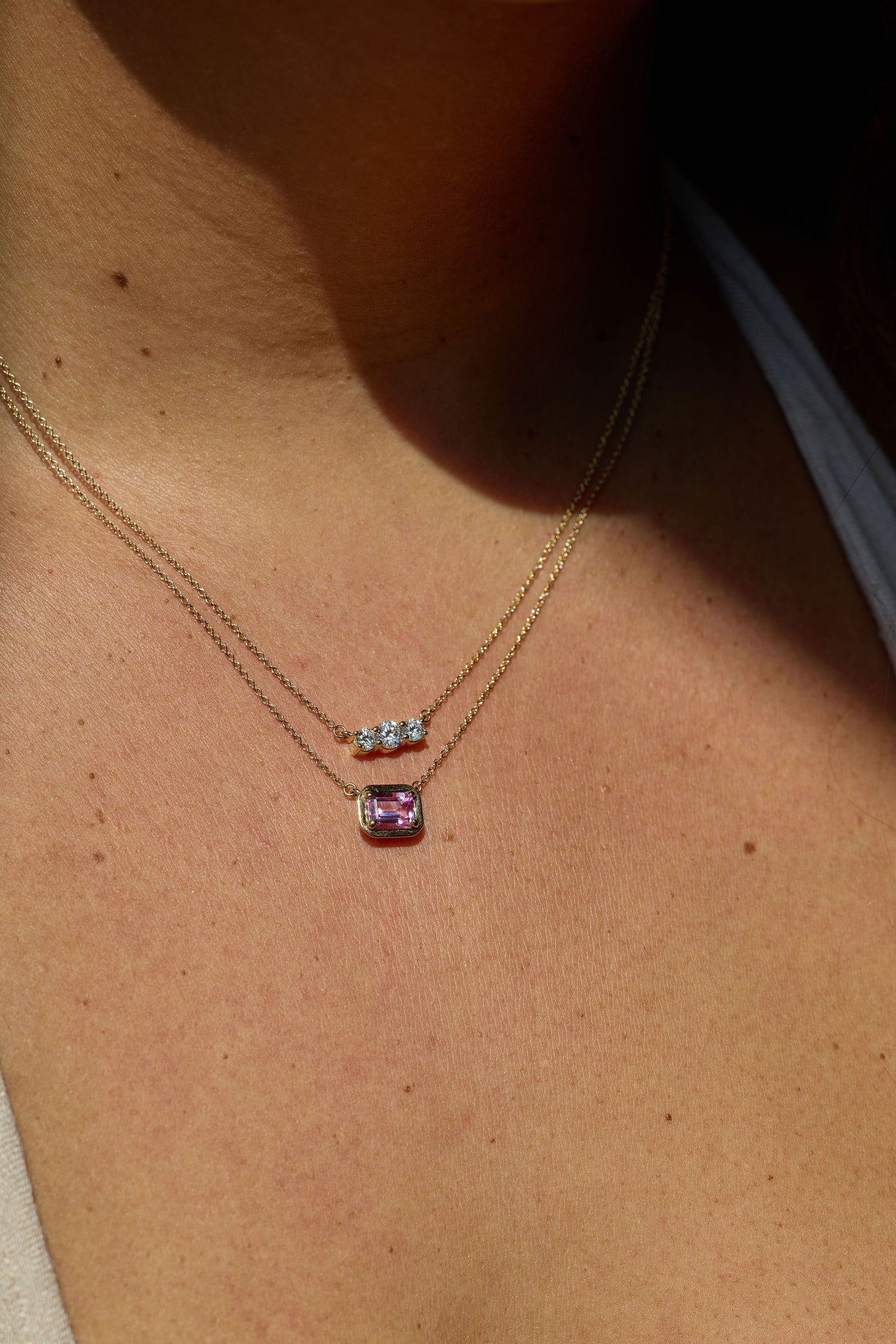 Necklace with two pendants on a person's neck