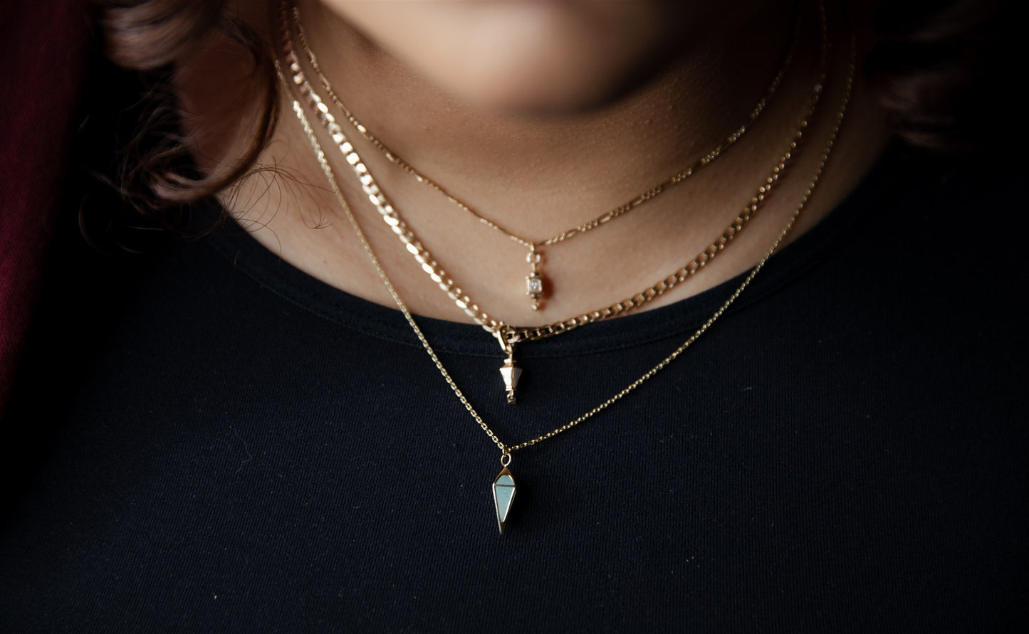 short pendulum necklace on a model