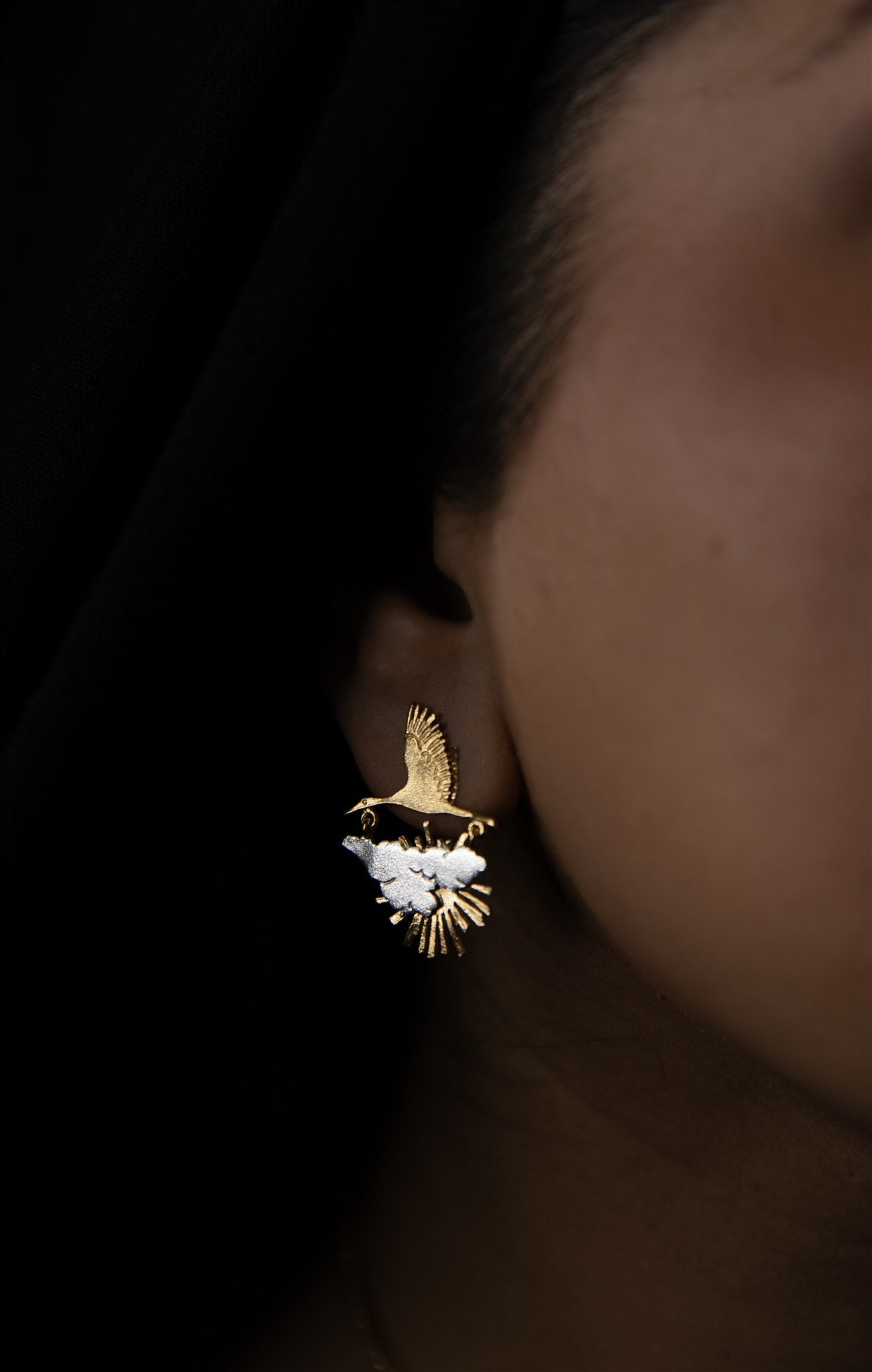 the sunrise crane earrings on model