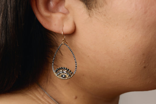 lotus dropped earrings on model