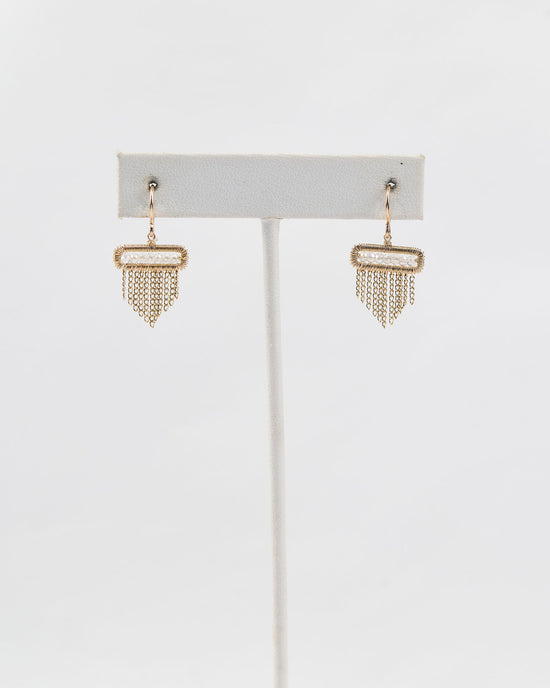 Dainty quartz earrings on earring stand
