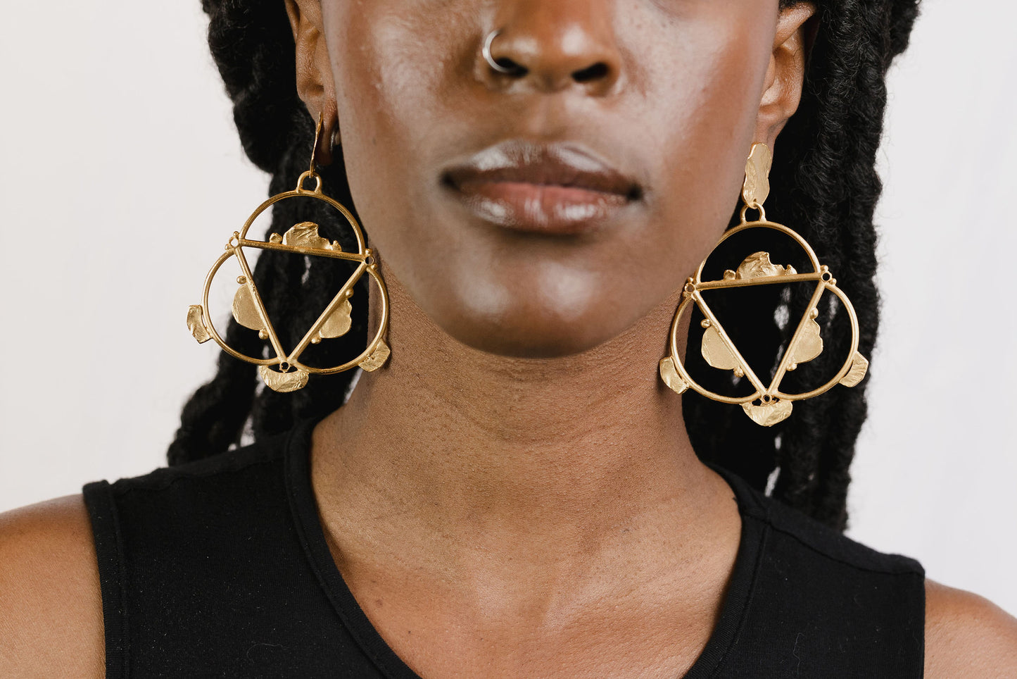 Hand of trinity earrings on model