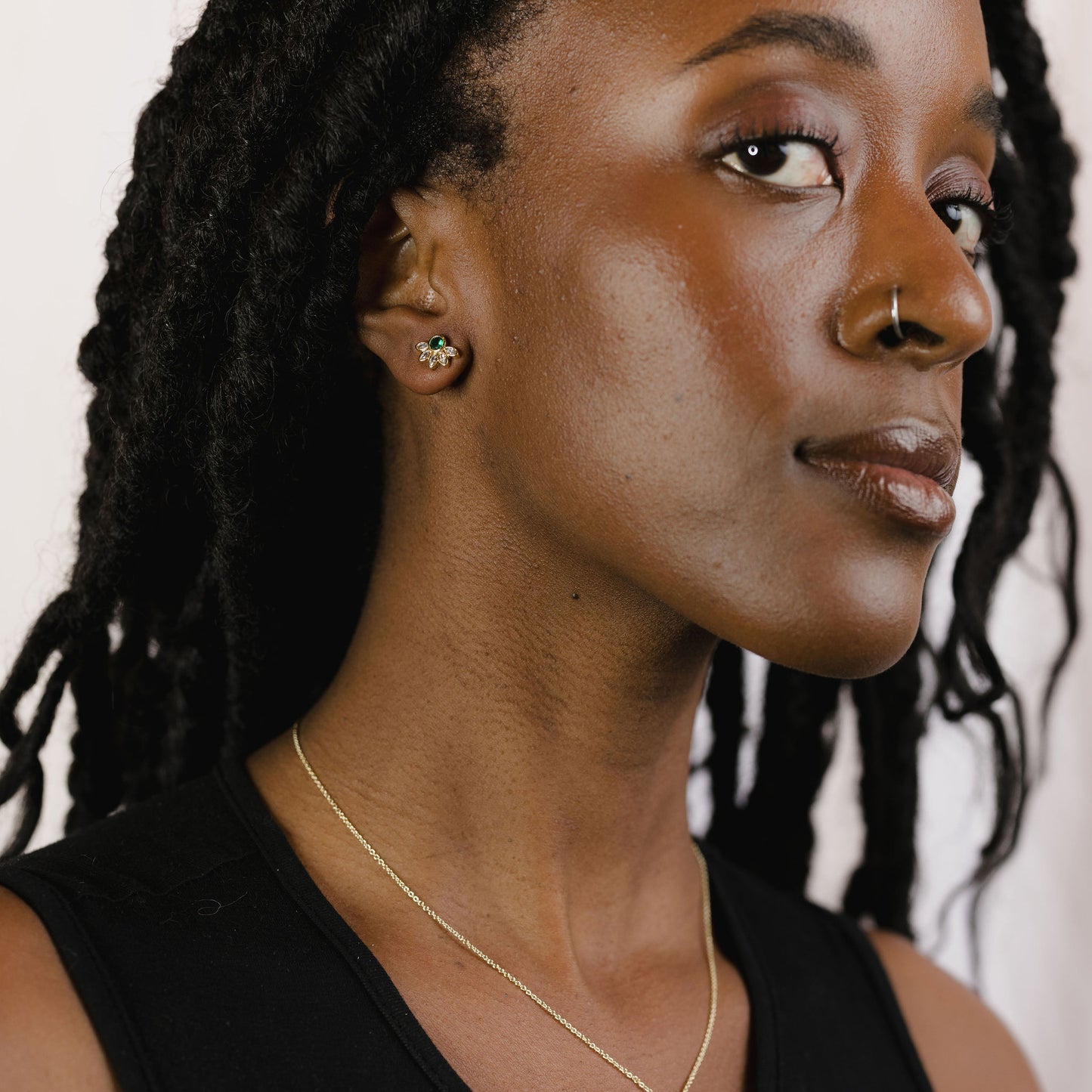 Marquise crown gemstone studs on a model