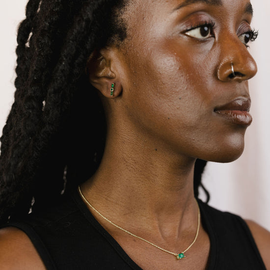 Emerald baguette studs on a model
