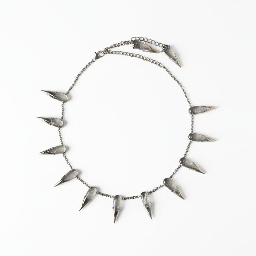 Spiked necklace on a brown textured background