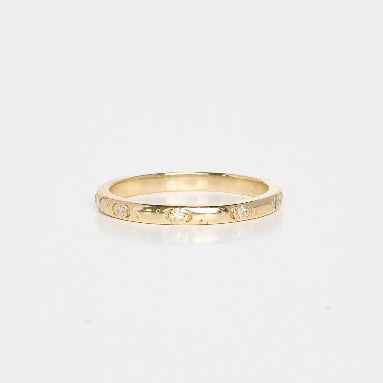 Gold ring on a light beige background