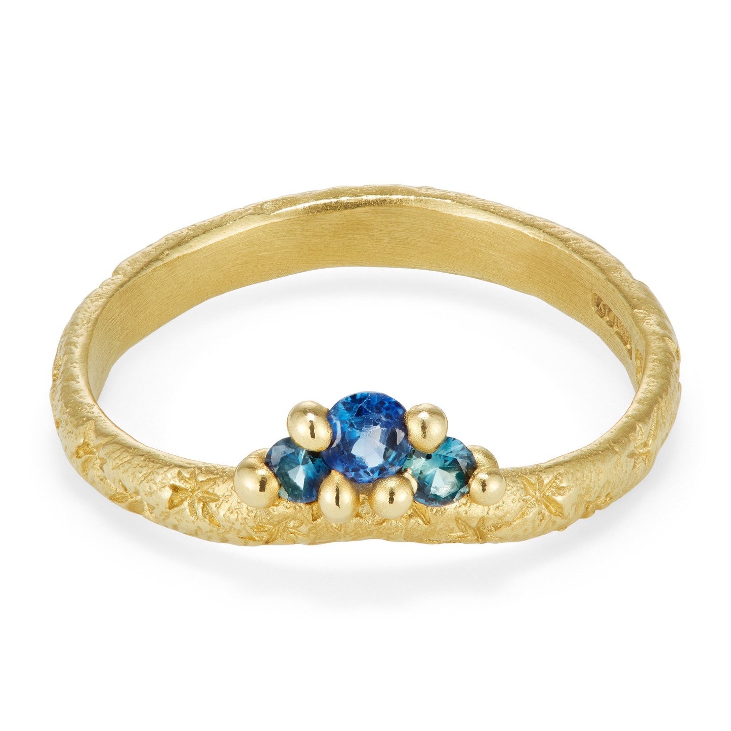 gold star engraved contour band with three round blue sapphires on white background