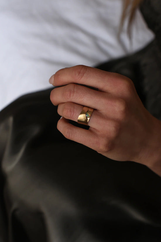 close up of a model wearing the opal brass high polish ring