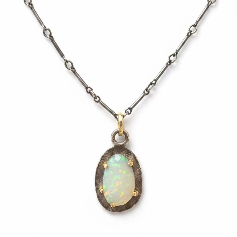Necklace with an opal pendant on a black background