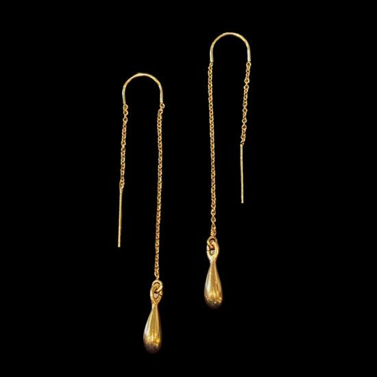 two gold threader earrings with a teardrop shaped gold charm