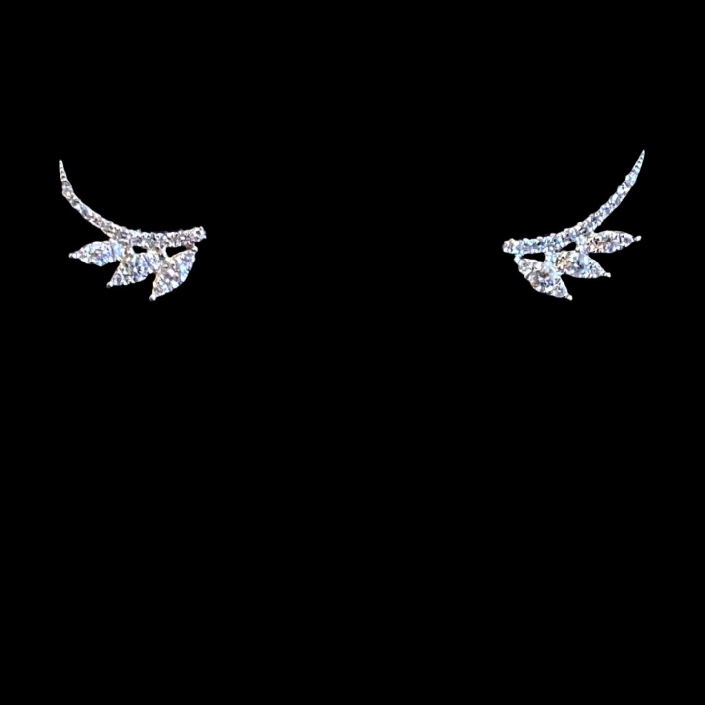 white gold stud earrings in the shape of an arc with three marquise shaped leaves coming off the side on a white background