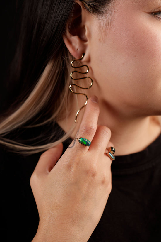 serpens earrings on model