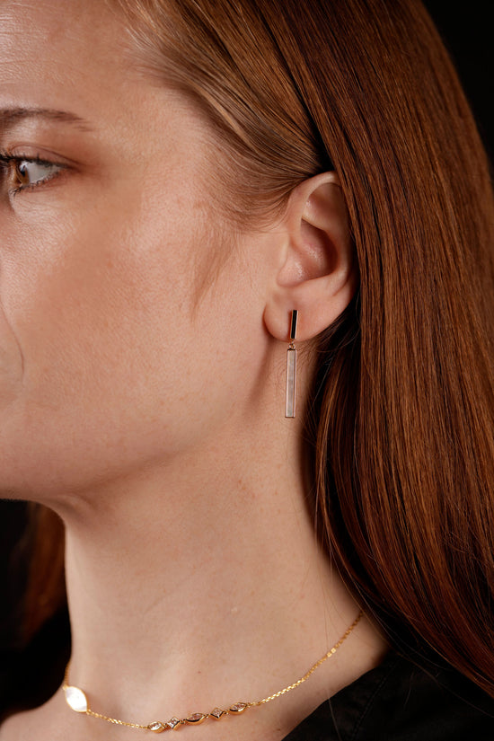mother of pearl drop studs on model