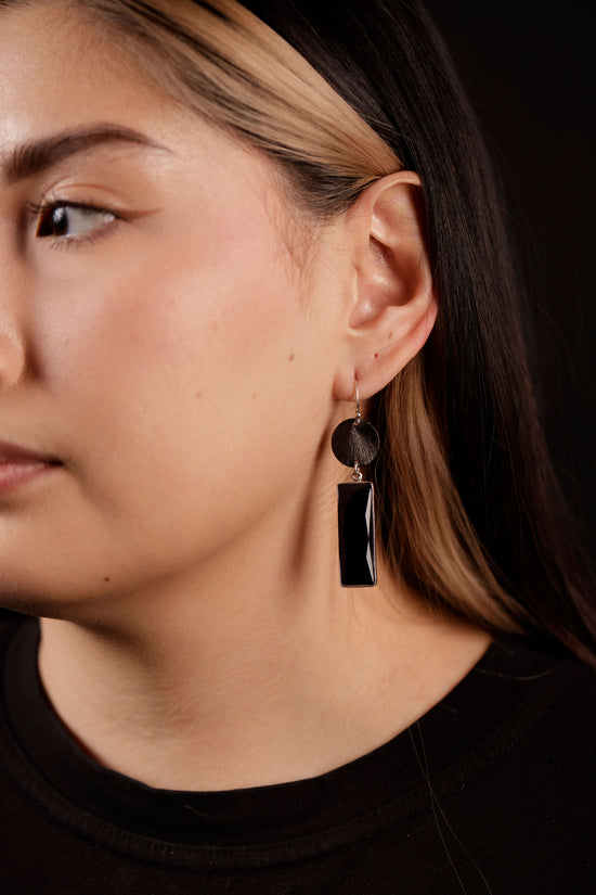 disc dangle earrings on model
