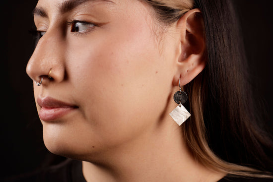 Load image into Gallery viewer, Radiant disc dangle earrings on model
