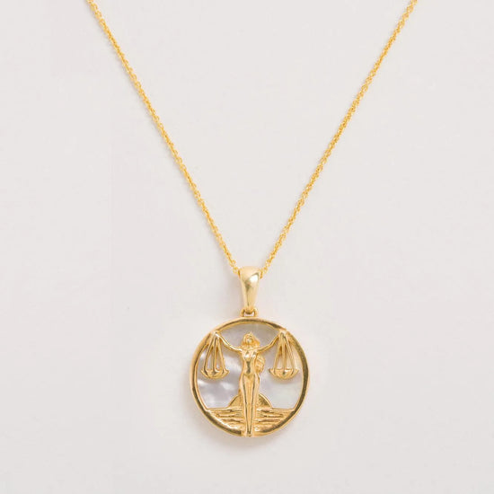 Libra pendant necklace on a white background