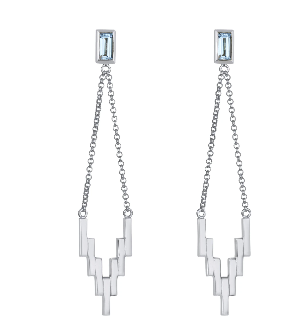 White gold dangle earrings with a blue rectangular stone post chained to zig zag drops 