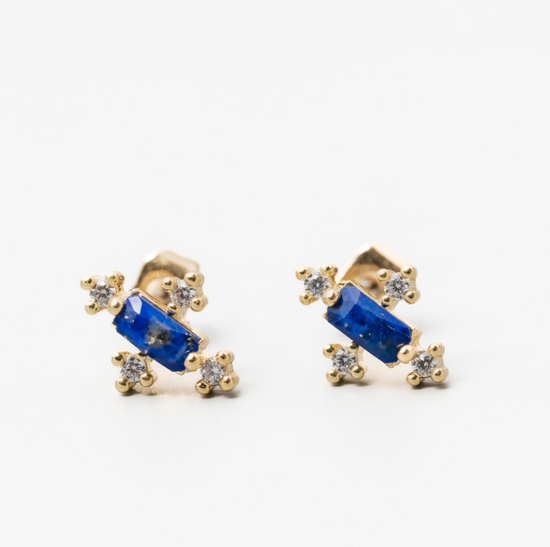 the paris earrings with a baguette shaped blue lapis gemstone center stone, cubic zirconia accents on a white background