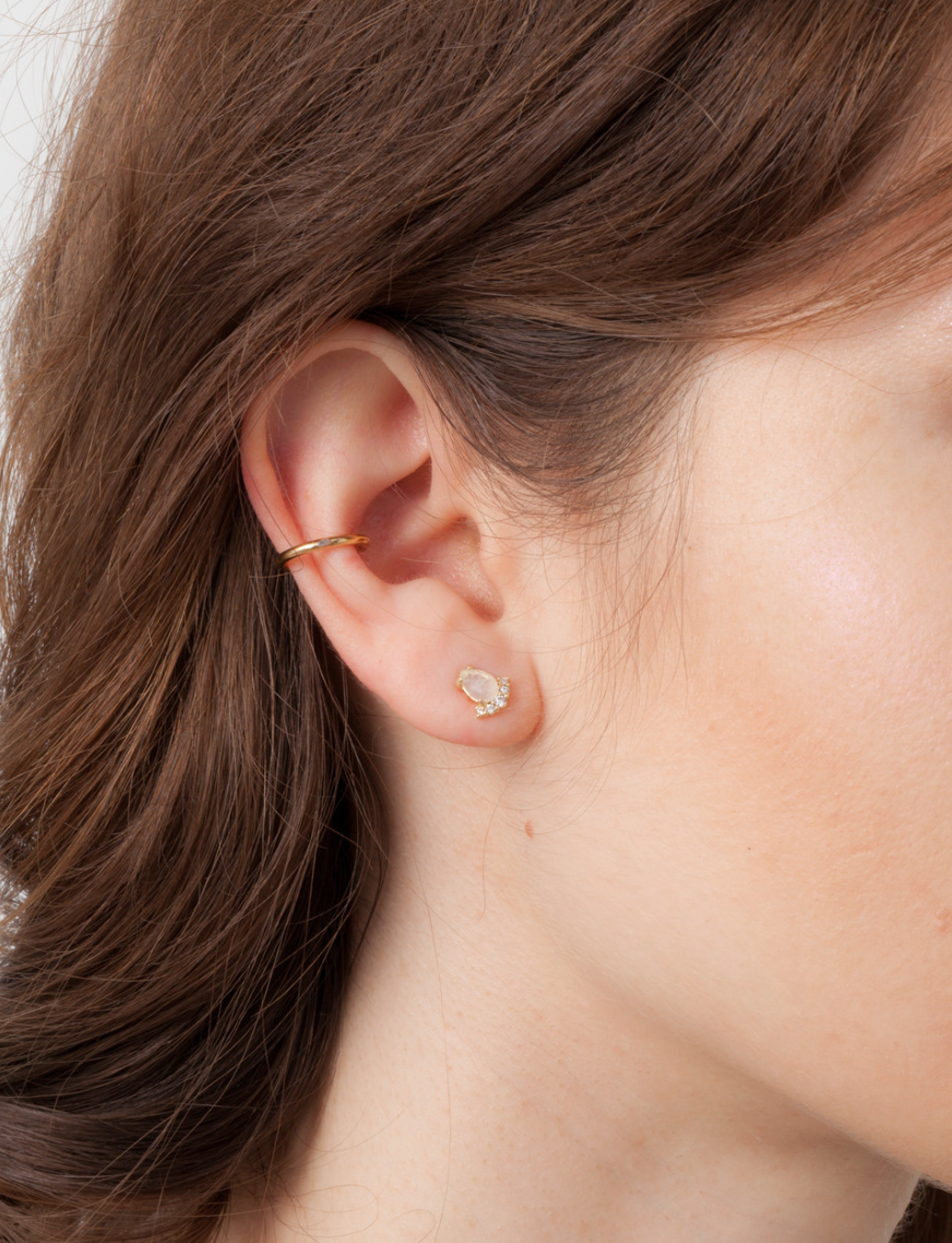 close up of a model wearing the stella stud earrings