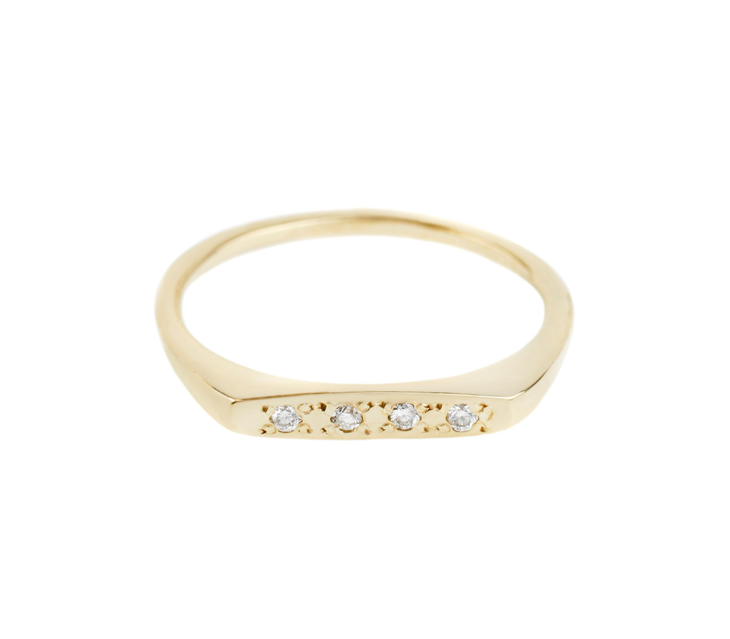 yellow gold bar signet ring with four white diamonds on a white background