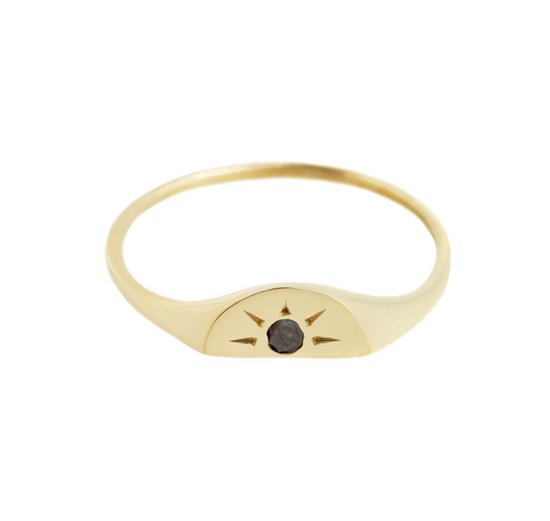 half moon shaped gold signet ring with black diamond center stone and engraved sun burst details. On white background