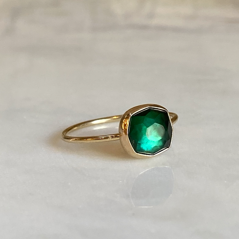 green tourmaline ring on marble