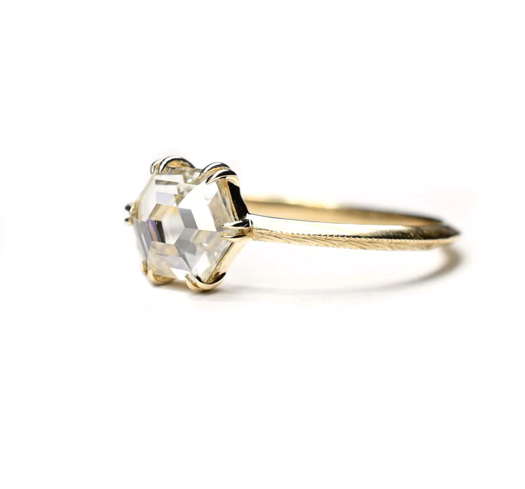 Load image into Gallery viewer, angled view of the hexagon rose cut diamond solitaire ring with engraved details on it&amp;#39;s knife edge band, sitting on a white background
