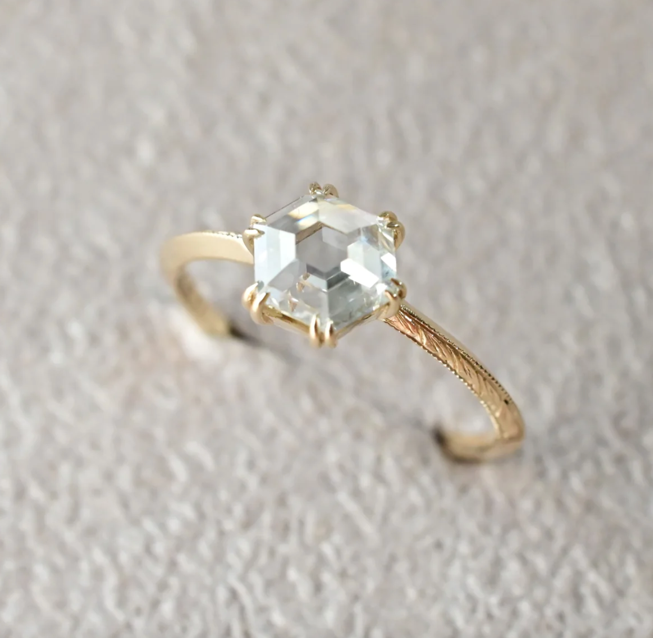 Load image into Gallery viewer, a hexagon rose cut diamond solitaire angled in a soft grey background
